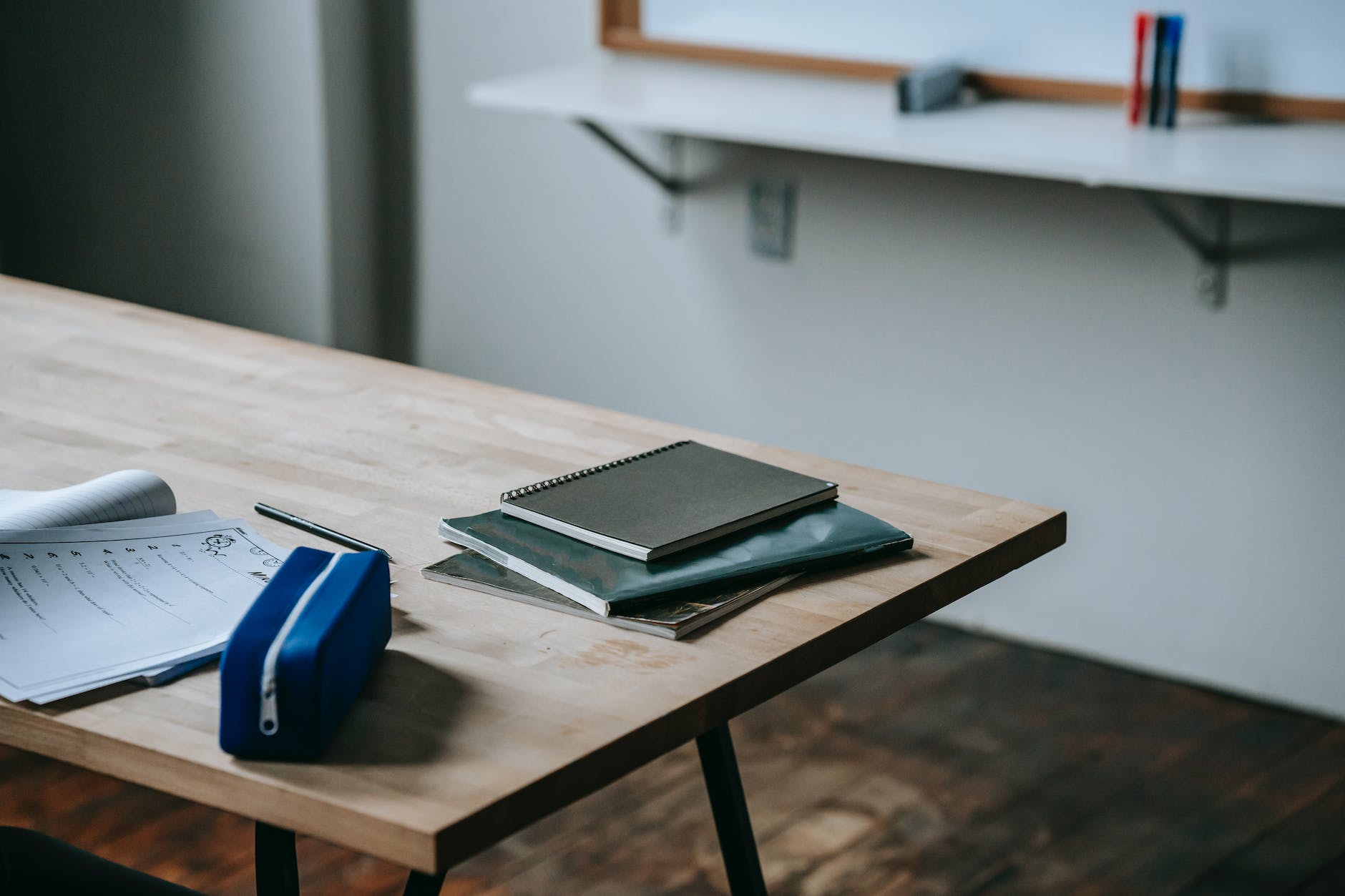 student desk with copybooks and pencil case