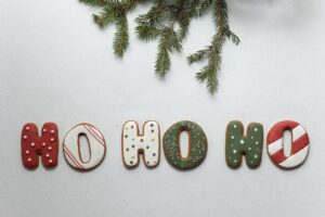 set of christmas sweets arranged with spruce twig on white table
