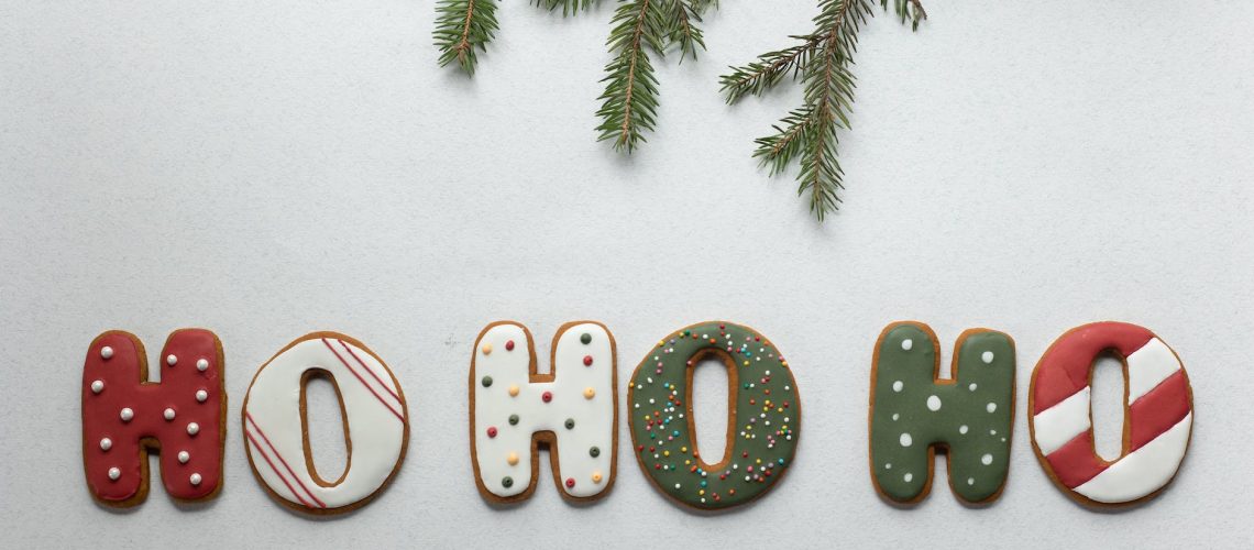 set of christmas sweets arranged with spruce twig on white table