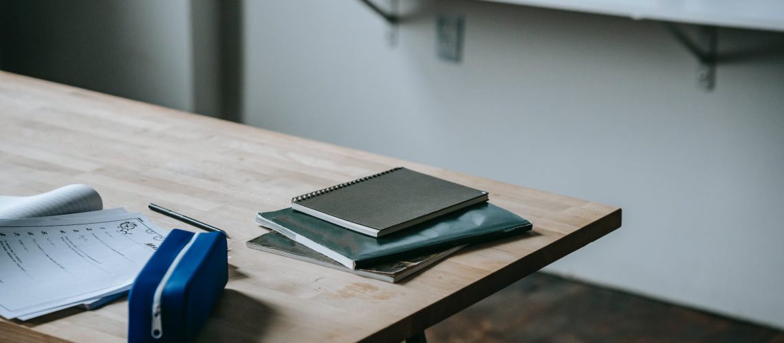 student desk with copybooks and pencil case