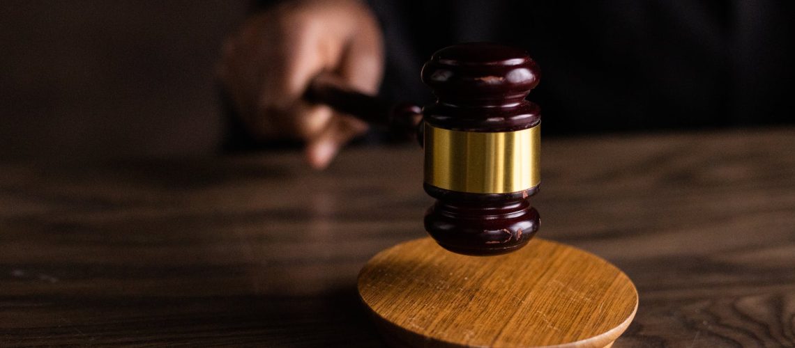 brown wooden gavel on brown wooden table